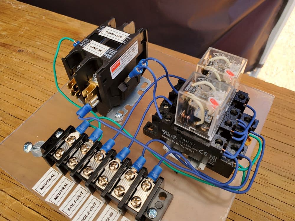 Electrical relay setup with labeled connections for automation and control applications.